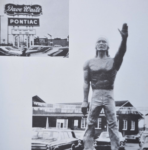 A indian stands at a Pontiac dealership